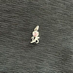 Sweet 16 charm with pink heart.